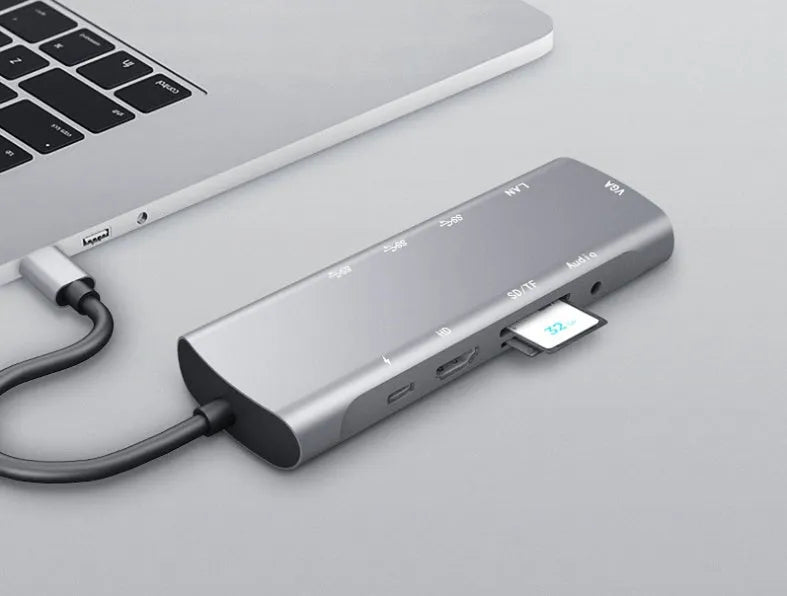 Grey USB-C docking station with HDMI, VGA, and USB ports on aluminium alloy body