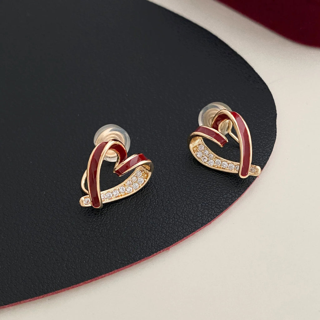 Fashion micro-set zircon asymmetric earrings in copper heart shape with love motif, available in red or white as ear clips or studs