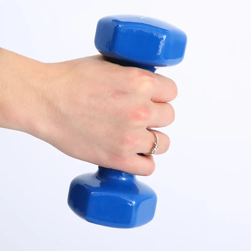 Brightly coloured plastic-coated fitness dumbbells in various weights on a floor.