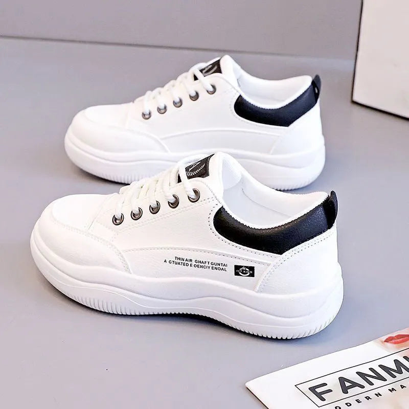 Women's white Korean-style low-top pumps with cross straps and lace-up front on a rubber sole.