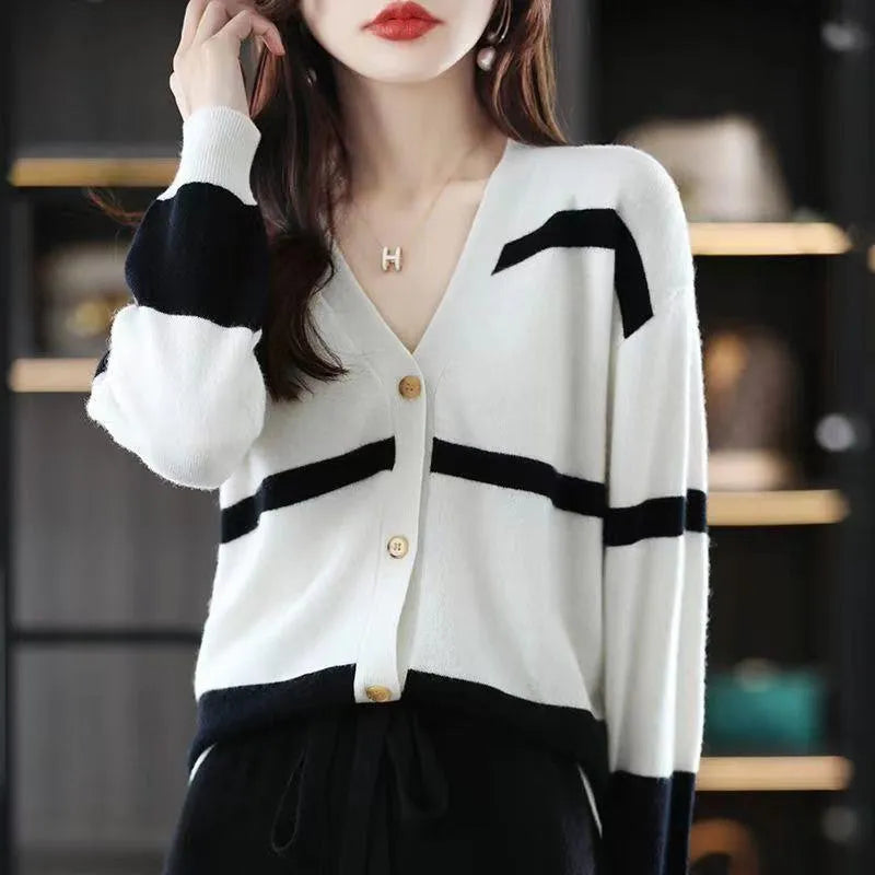 Women's striped V-neck knit cardigan buttoned up, shown in a slim fit.