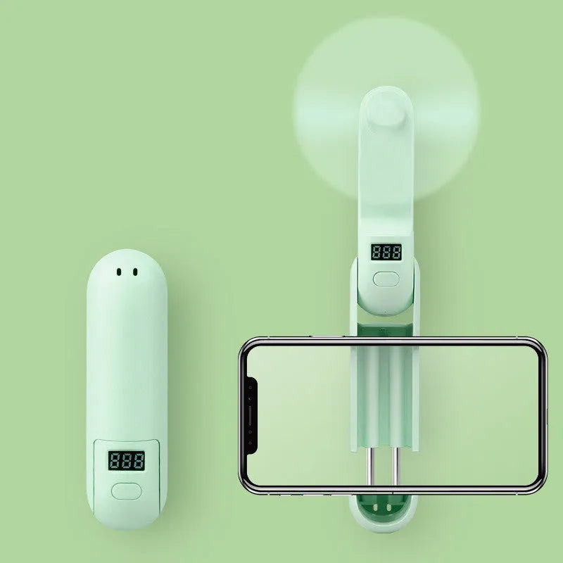 Green folding mini USB fan with plastic leaf blades, shown open and closed.