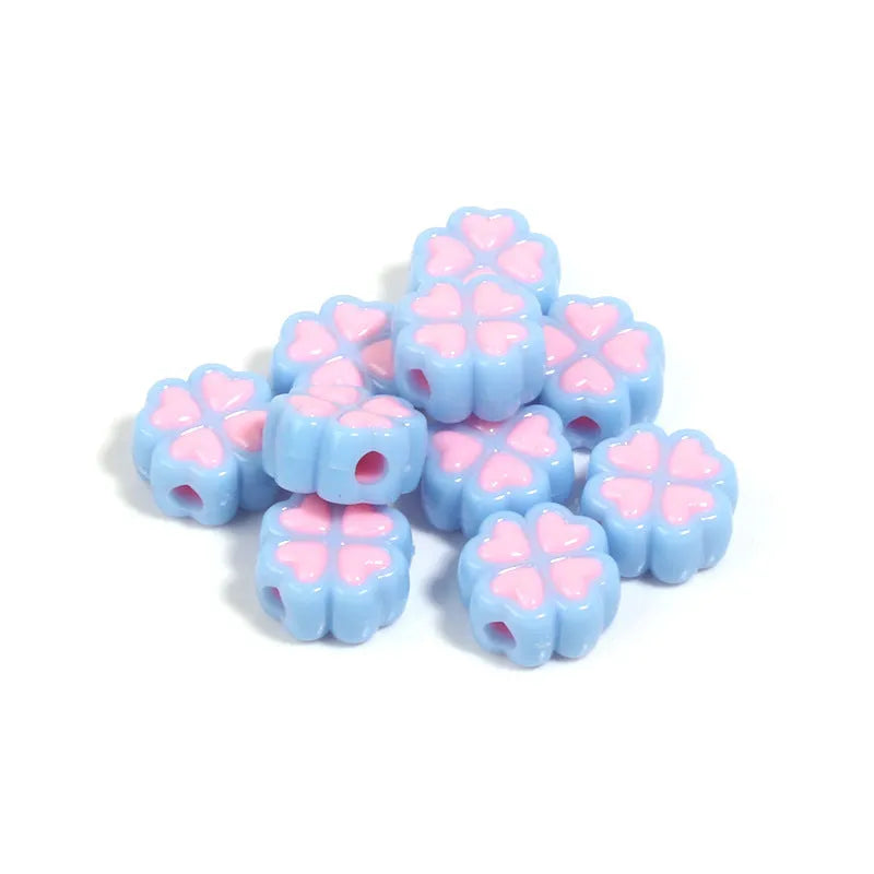 A selection of 15mm frosted acrylic beads in various colours, each showing a four-leaf clover love pattern.