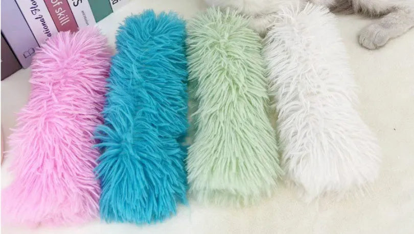 Plush cat toy pillow with crinkle material and wiggly tentacles in blue, green, pink, and white colour options.
