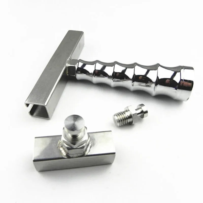 Car dent repair tool set with green adhesive labels and aluminium alloy supports on a workbench