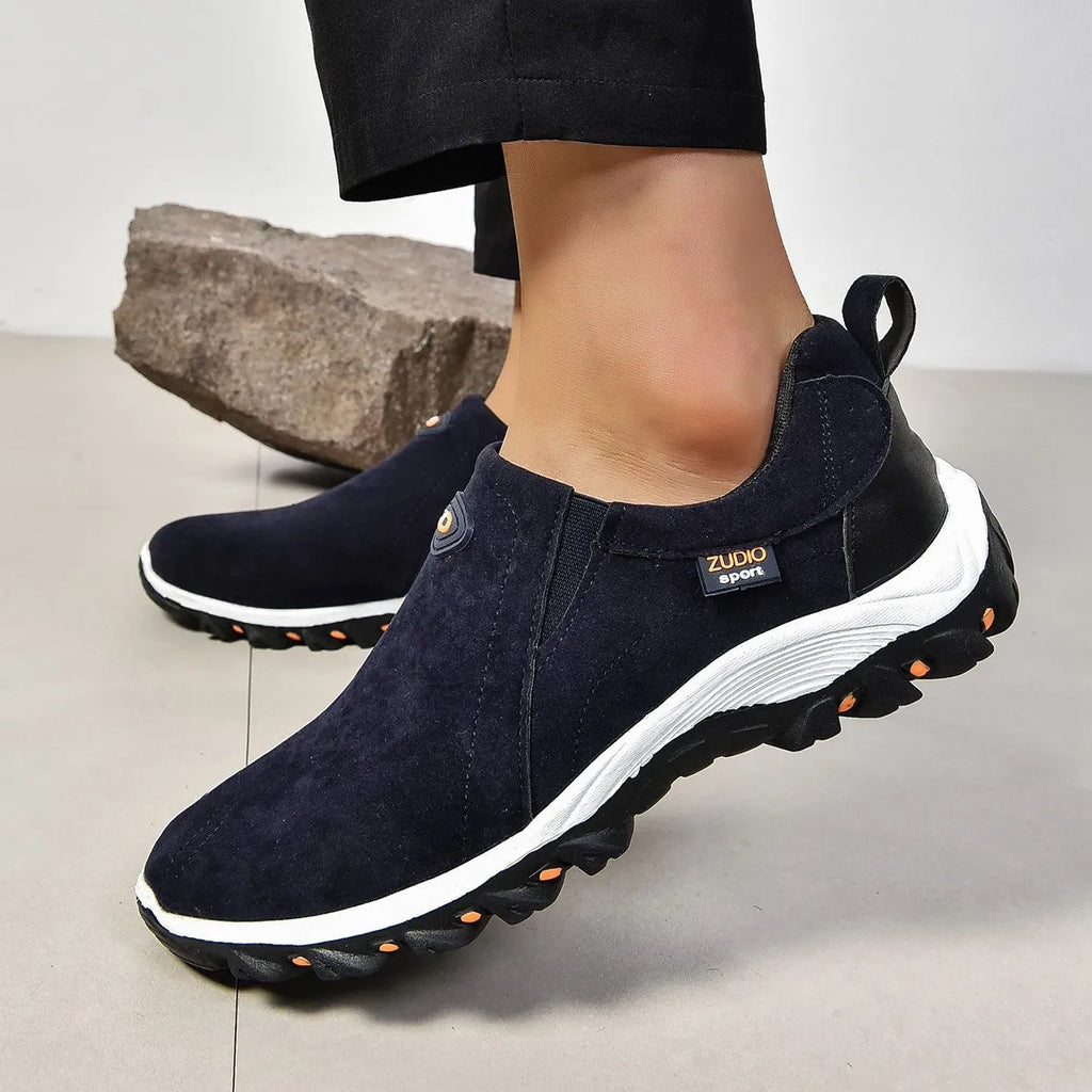 Men's gray round toe slip-on casual shoes with a rubber sole on a plain background.