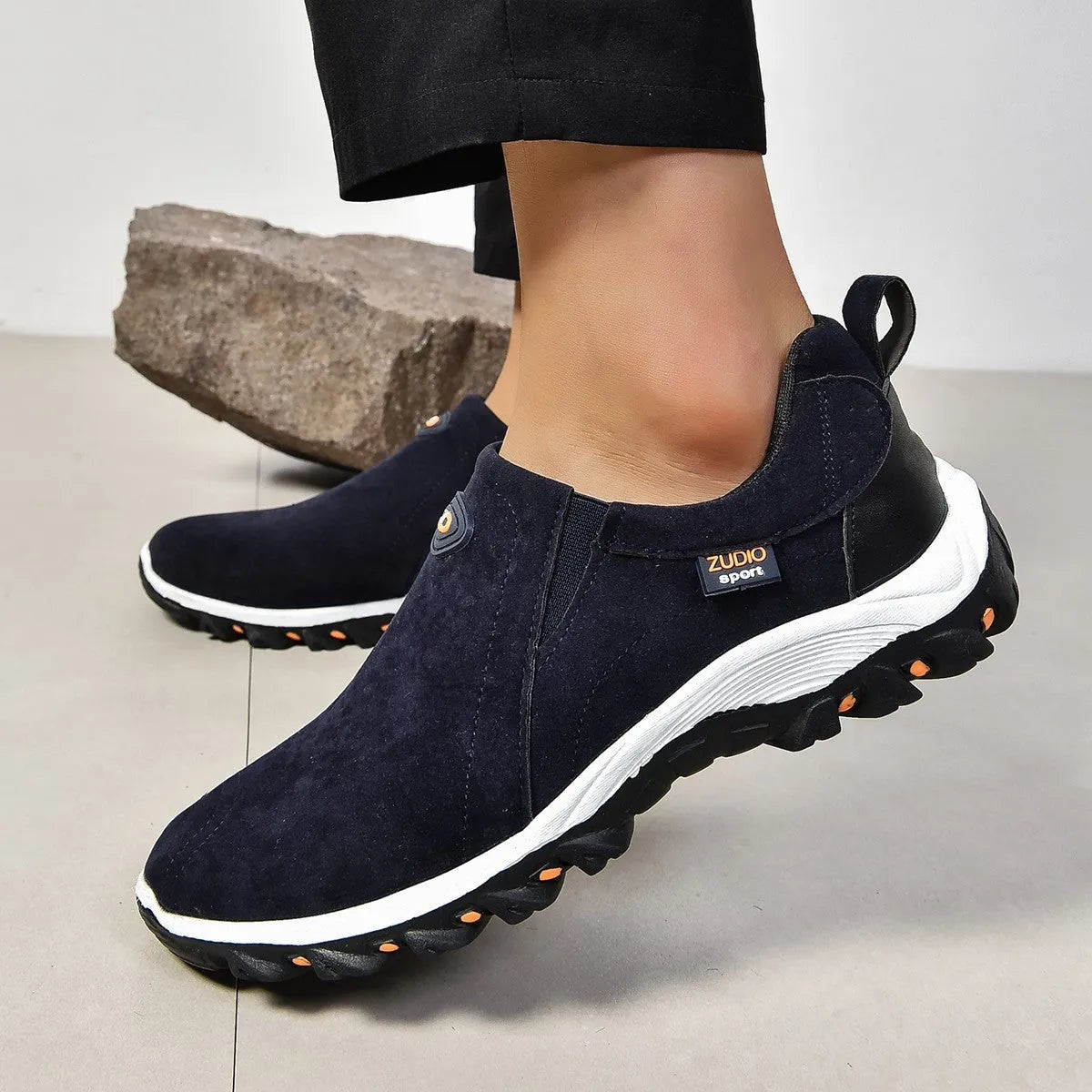 Men's gray round toe slip-on casual shoes with a rubber sole on a plain background.
