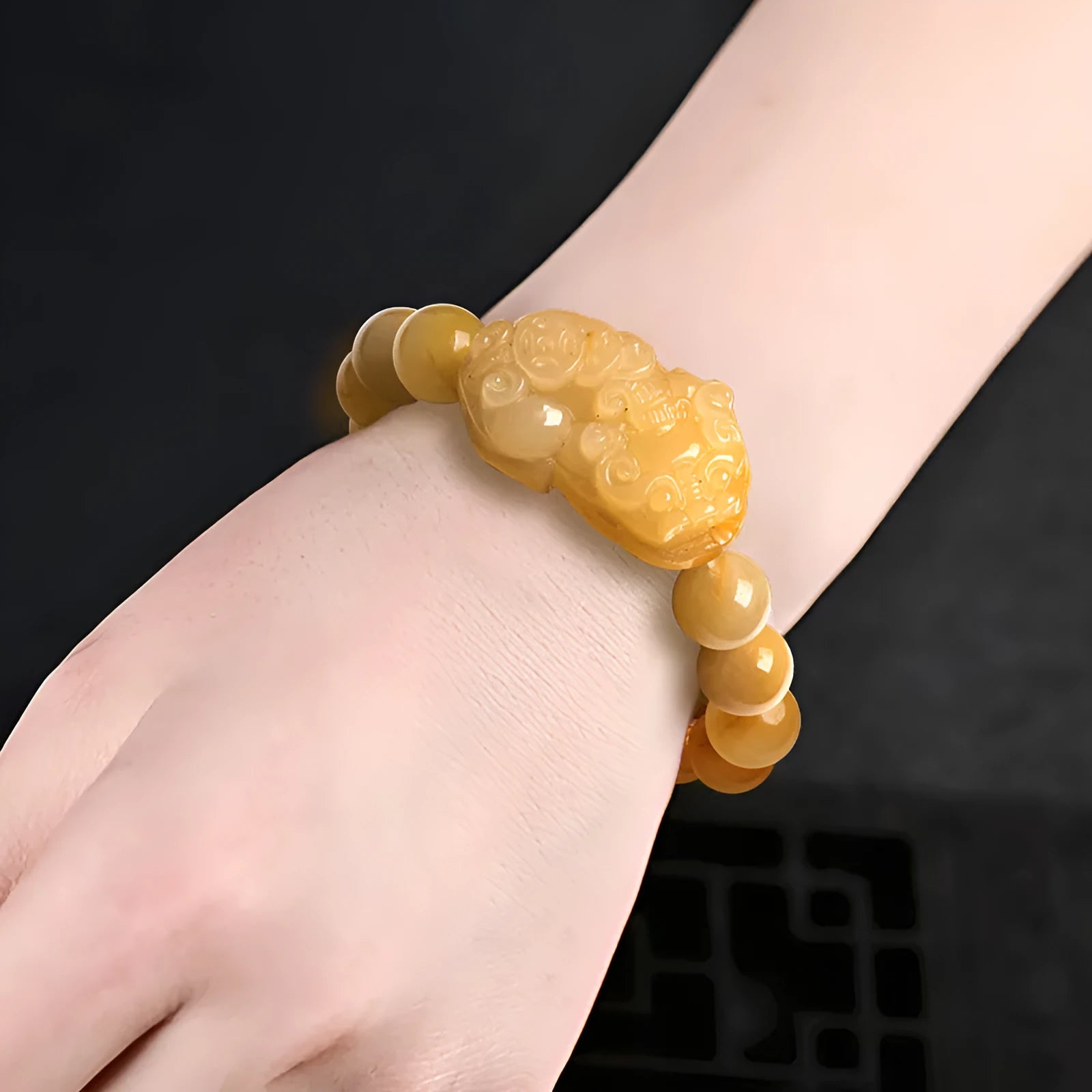 Hand-carved Jinsi Jade money bracelet with traditional coin pendant in golden-threaded stone