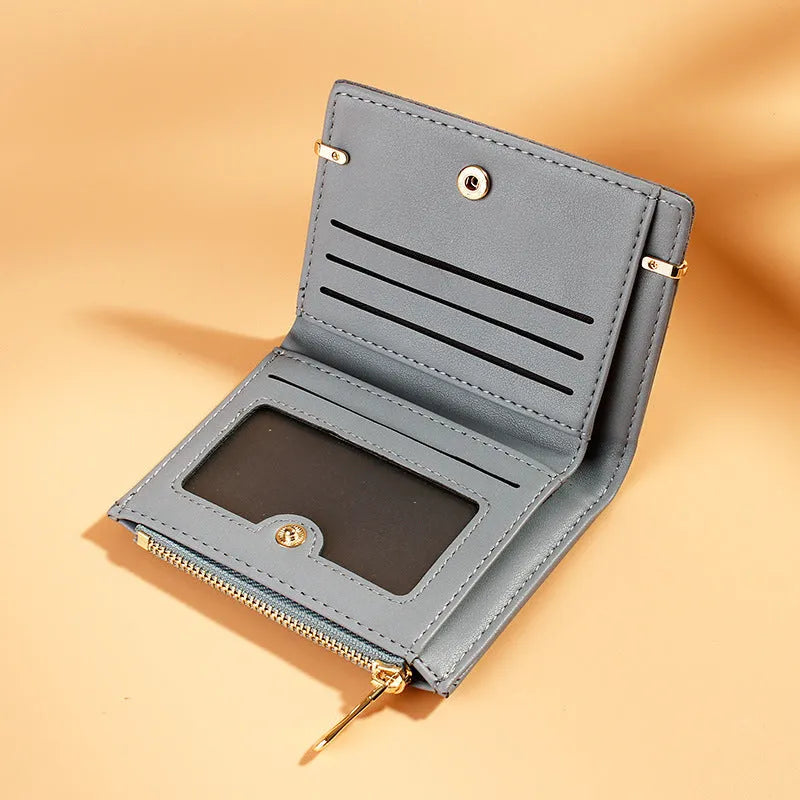 Ladies folded short wallet with zipper closure in PU leather, shown open to reveal multiple card slots and internal compartments.