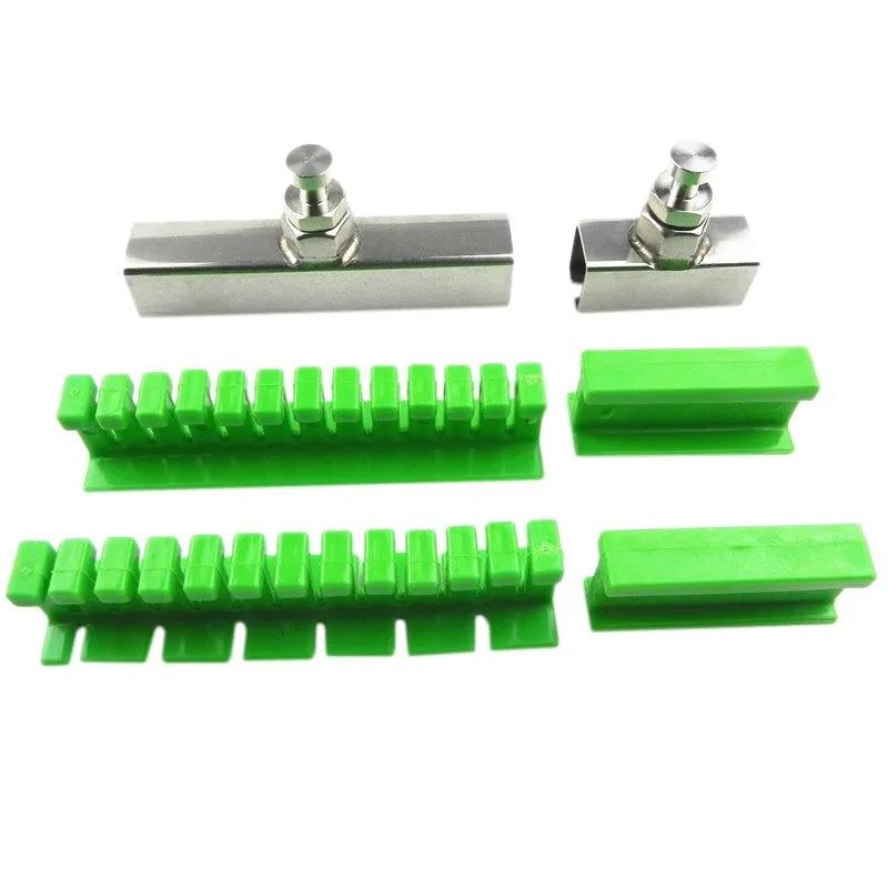 Car dent repair tool set with green adhesive labels and aluminium alloy supports on a workbench