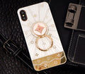 Gold iPhone ring stand with diamond accents holding iPhone for hands-free viewing