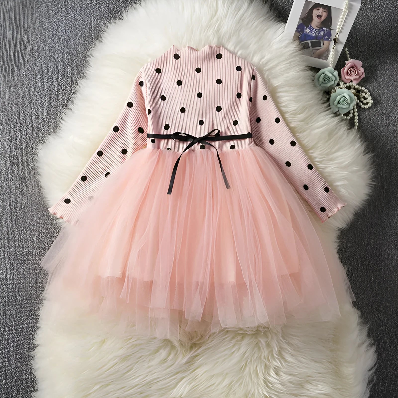 Baby girl in a long sleeve black tutu lace dress for a birthday party.