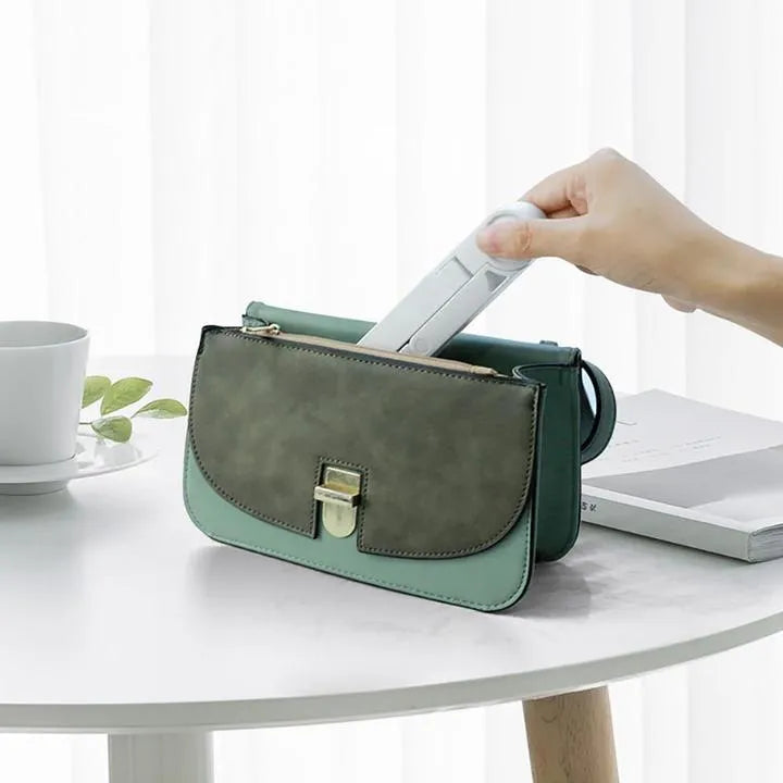 Black foldable tablet holder supporting tablet in landscape position on desk