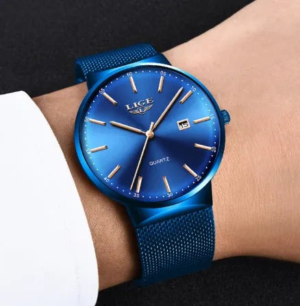 Men's stainless steel watch with 40mm dial on a wrist, showing slim profile.