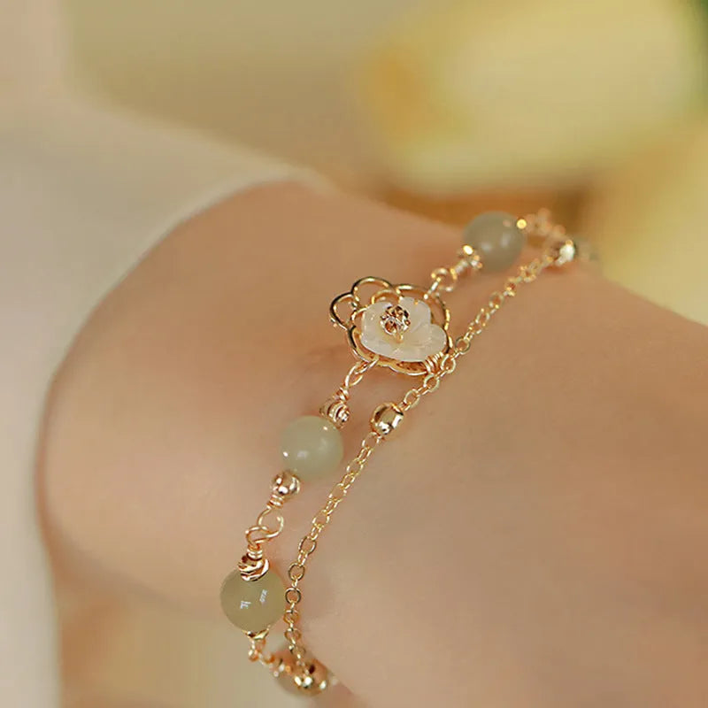 Yellow gold electroplated copper butterfly bracelet with geometric shape and bells of Ireland Hetian jade charm