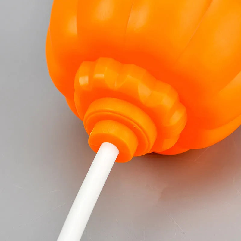 Plastic pumpkin-shaped decorative lamp with USB charging port, shown with purple or yellow light option.