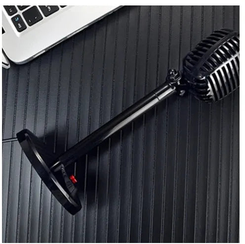 Black USB desktop computer microphone on a stable stand with an adjustable neck.