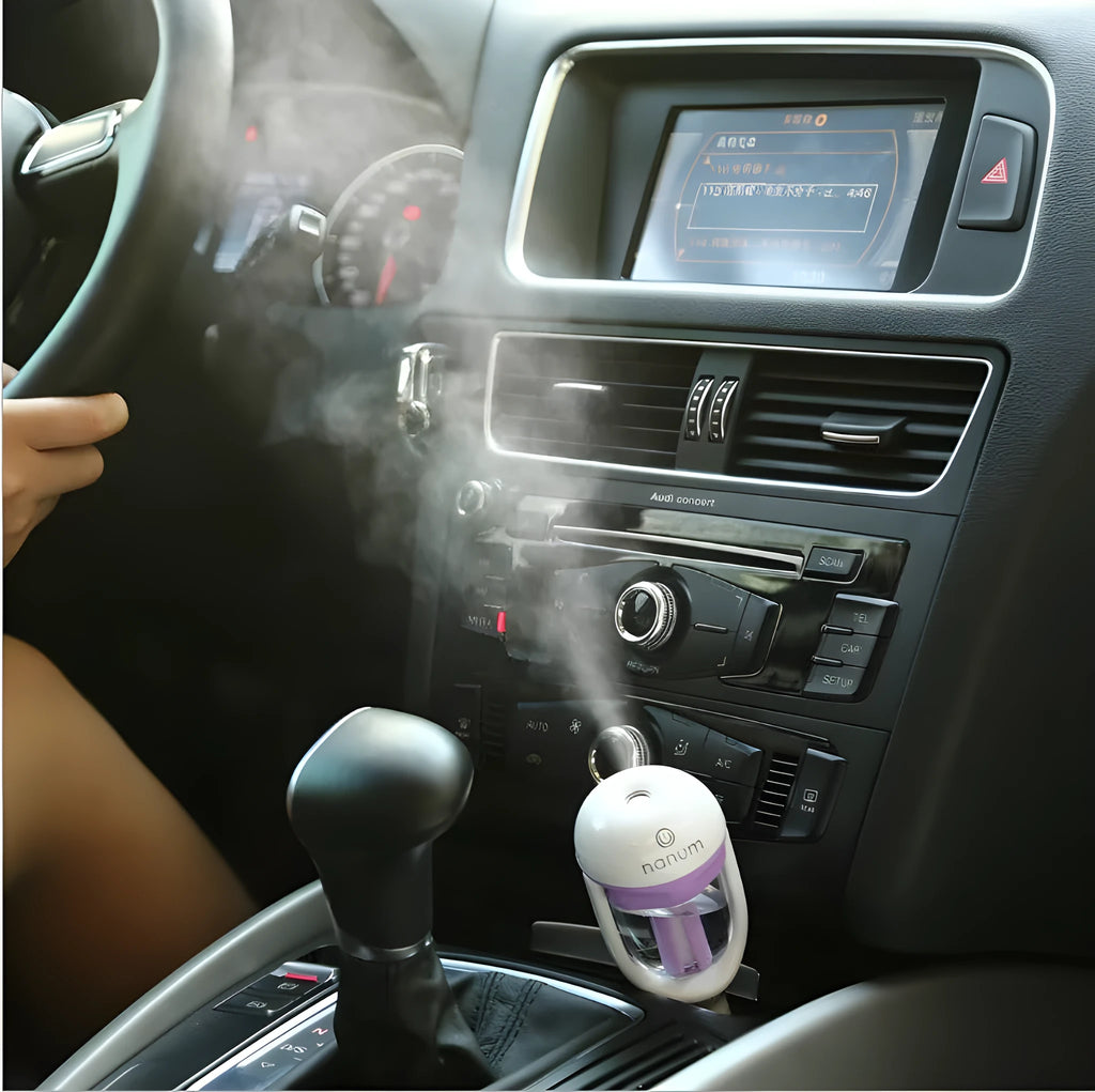 Compact blue portable car humidifier and essential oil diffuser unit on a car dashboard