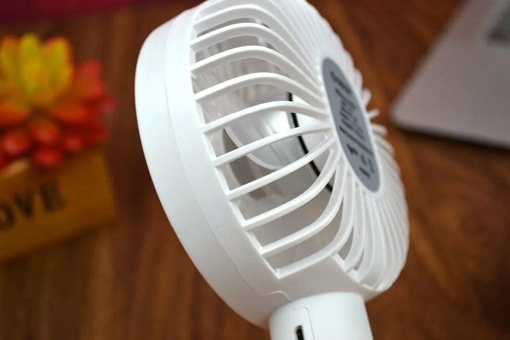 White ORICO FH1 USB rechargeable portable handheld and desktop fan with fine-line detailing.