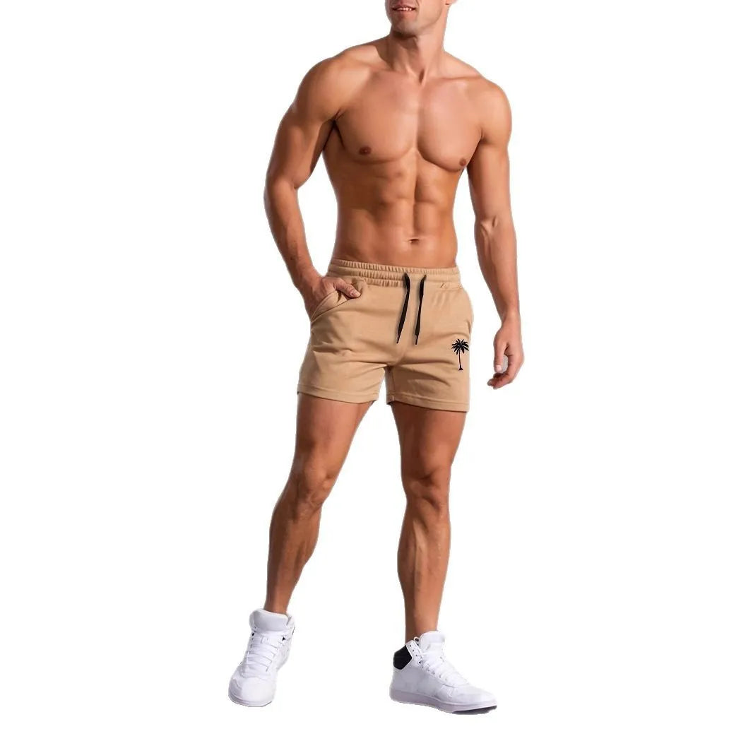 Men's khaki sports shorts with a coconut leaf print, showing straight-leg cut.
