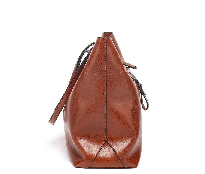 Horizontal waxed cowhide leather cross-body handbag showing two main compartments and phone pocket organisation