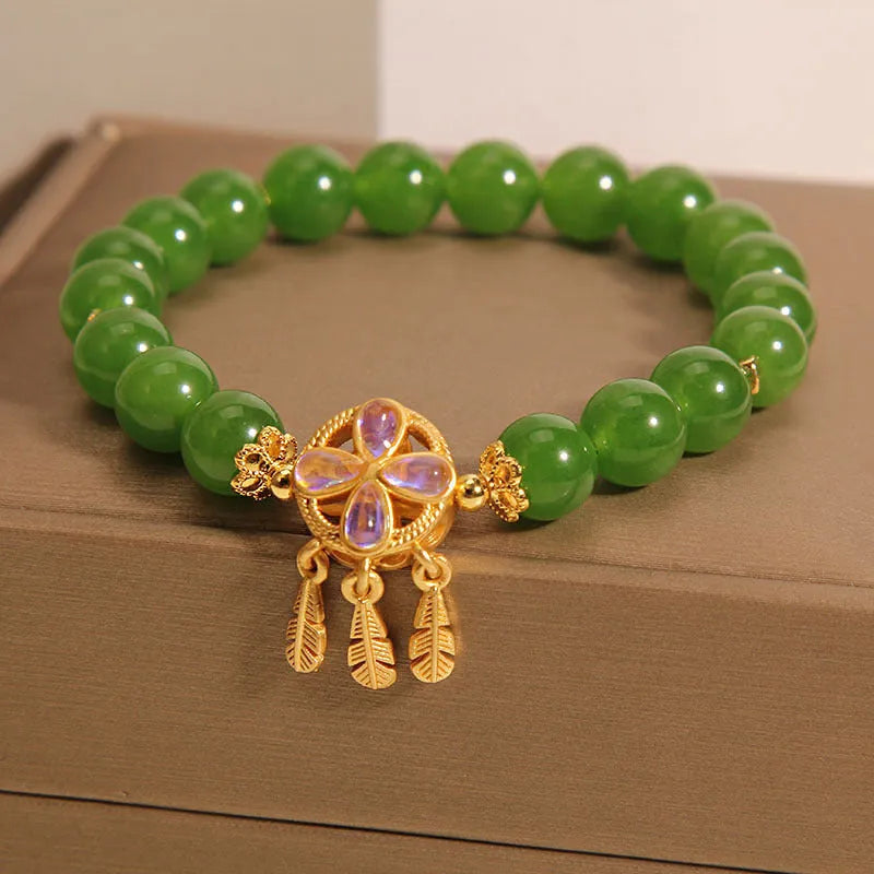 Green jasper bracelet for women with a four-leaf clover dream catcher crystal pendant on a chain.