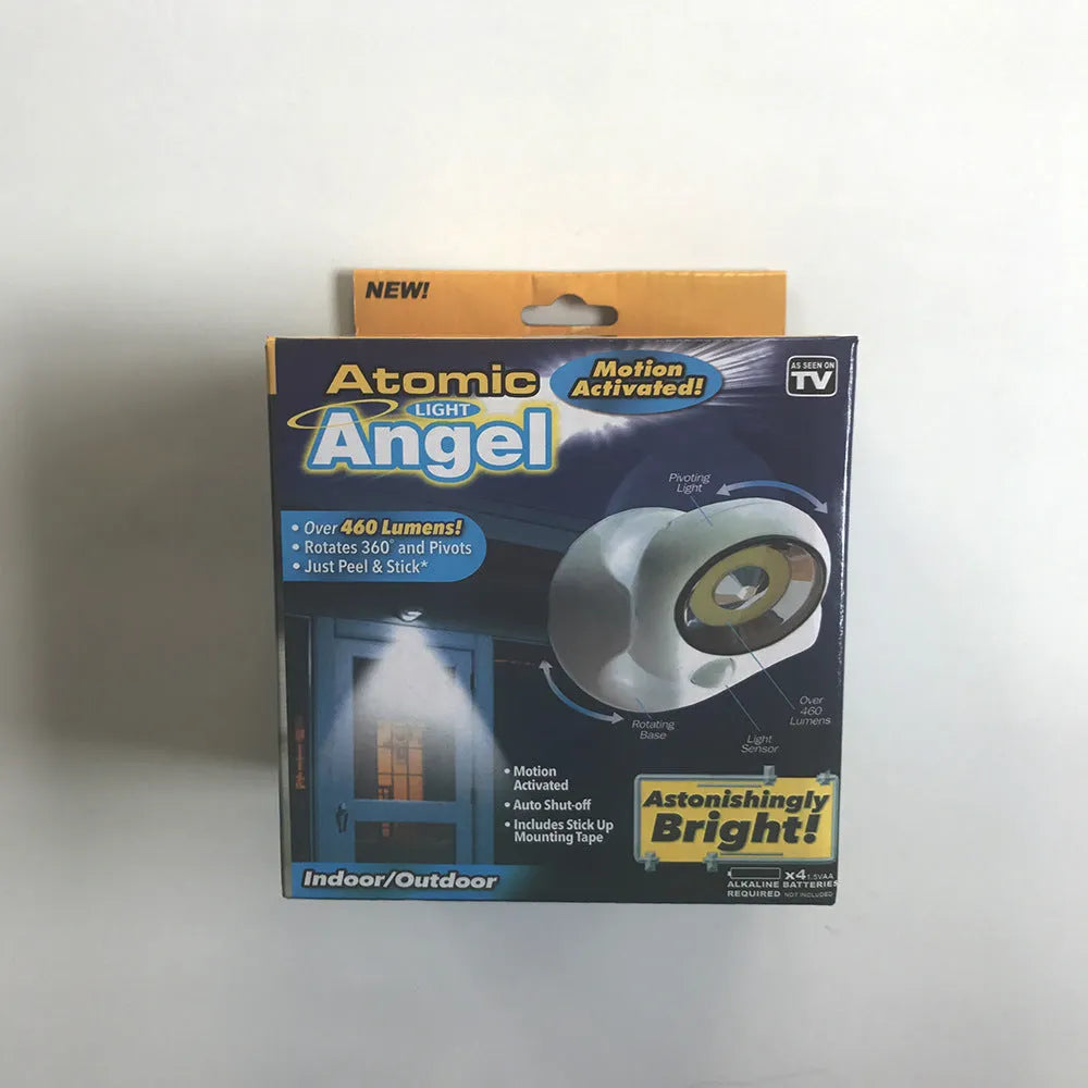 White Atomic Angel induction desk lamp on a wooden surface