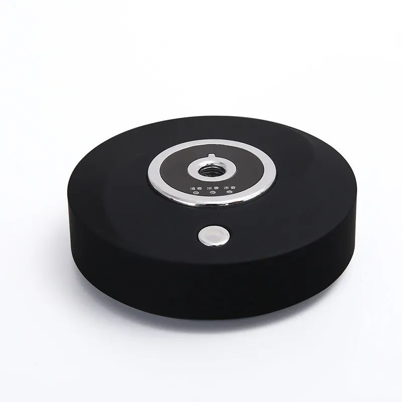 White plastic USB car aromatherapy machine with anti-slip pad on vehicle dashboard