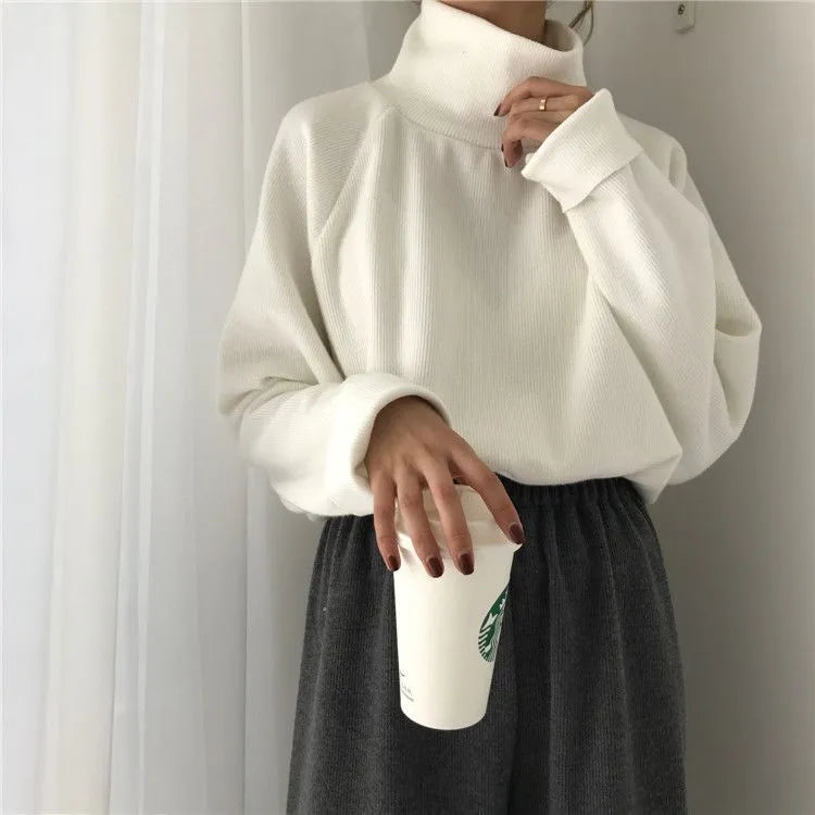Women's apricot coloured half-high collar long sleeve loose fit casual top on a hanger