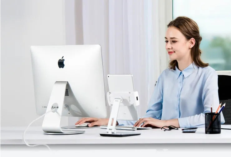 Black folding phone tablet holder with 360° rotating head on desktop