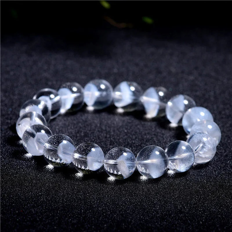 Women's original design white crystal pyramid bracelet with Ruyi charm on wrist.