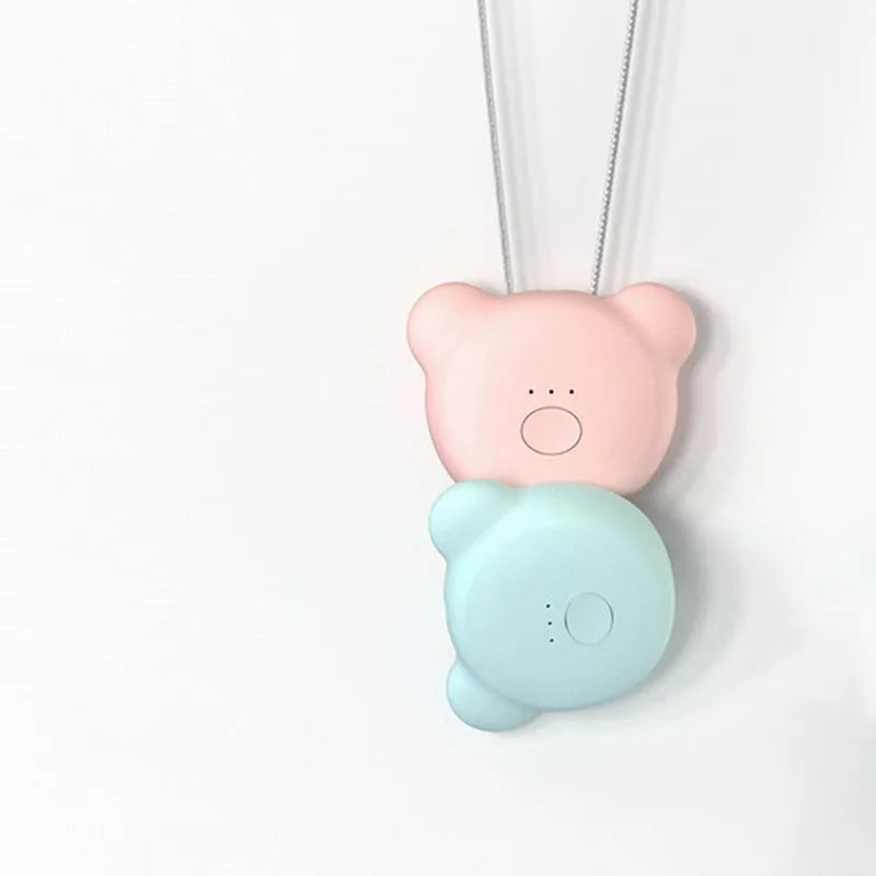 Mini USB air purifier pendant on a necklace, shown in pink colour with charging cable.