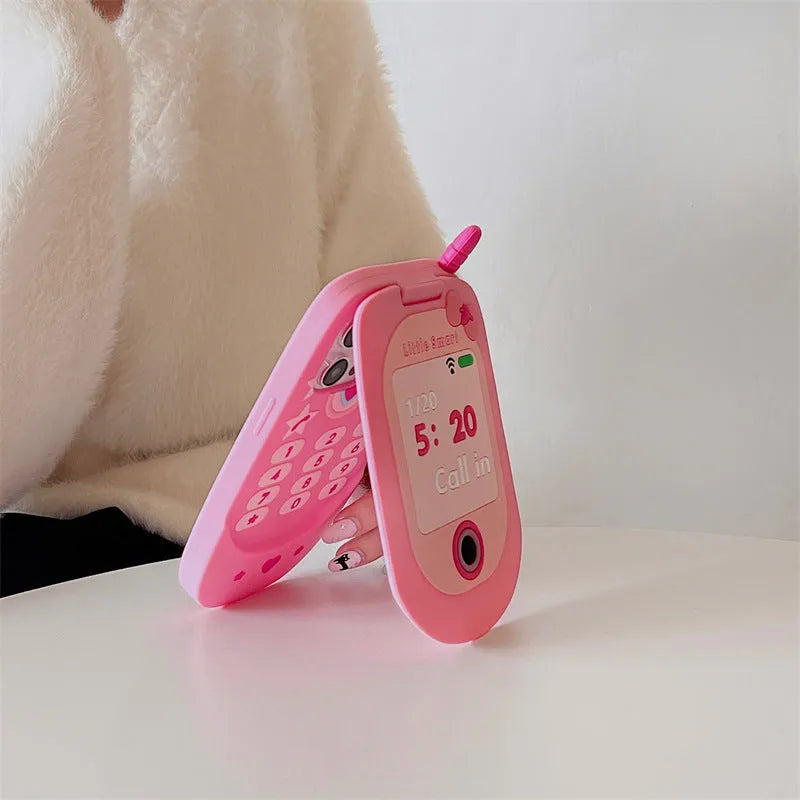 Pink silicone iPhone case shaped like a flip phone with a front mirror.