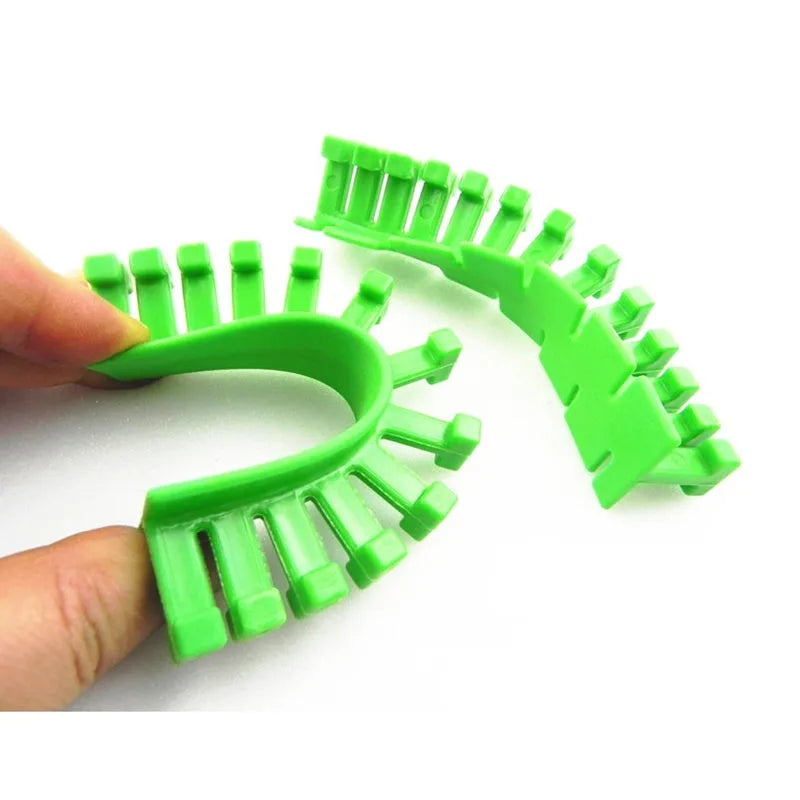 Car dent repair tool set with green adhesive labels and aluminium alloy supports on a workbench