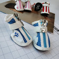 Set of four blue cloth dog shoes with zip closures and non-slip soles for small dogs.
