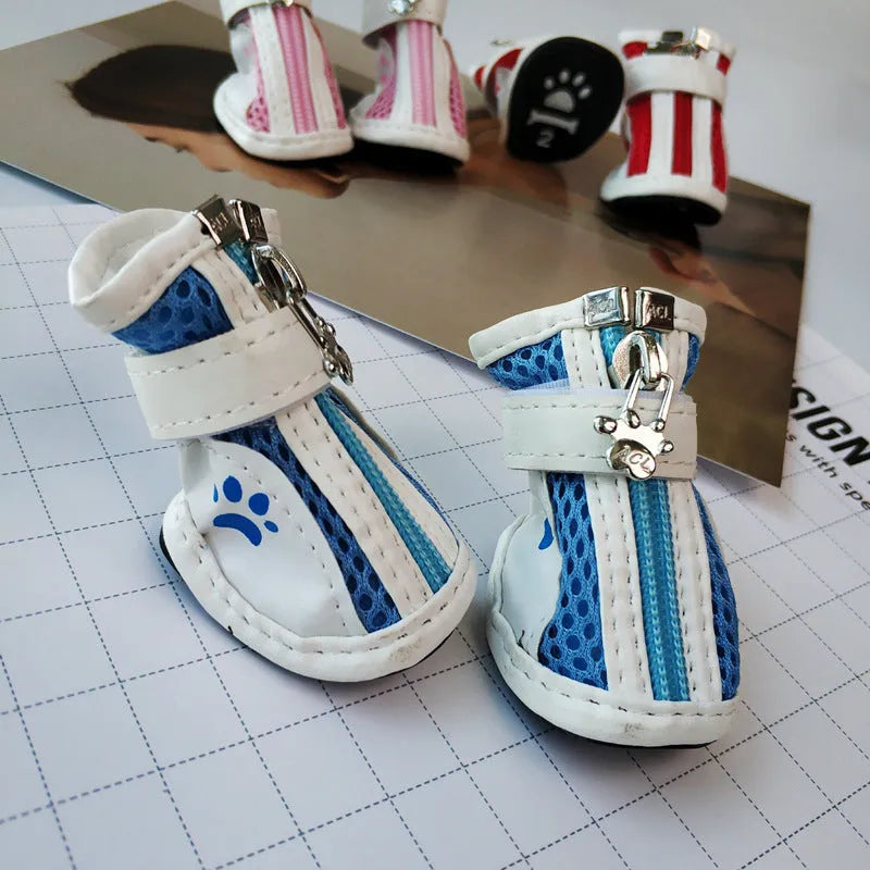 Set of four blue cloth dog shoes with zip closures and non-slip soles for small dogs.