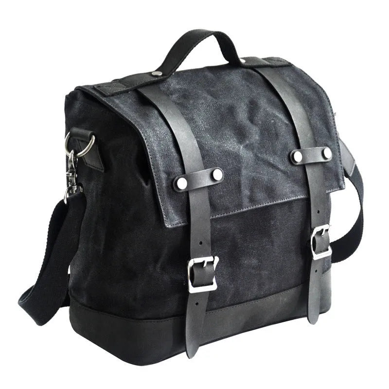 Black waterproof canvas motorcycle side pannier bag with cowhide reinforcement mounted on motorcycle