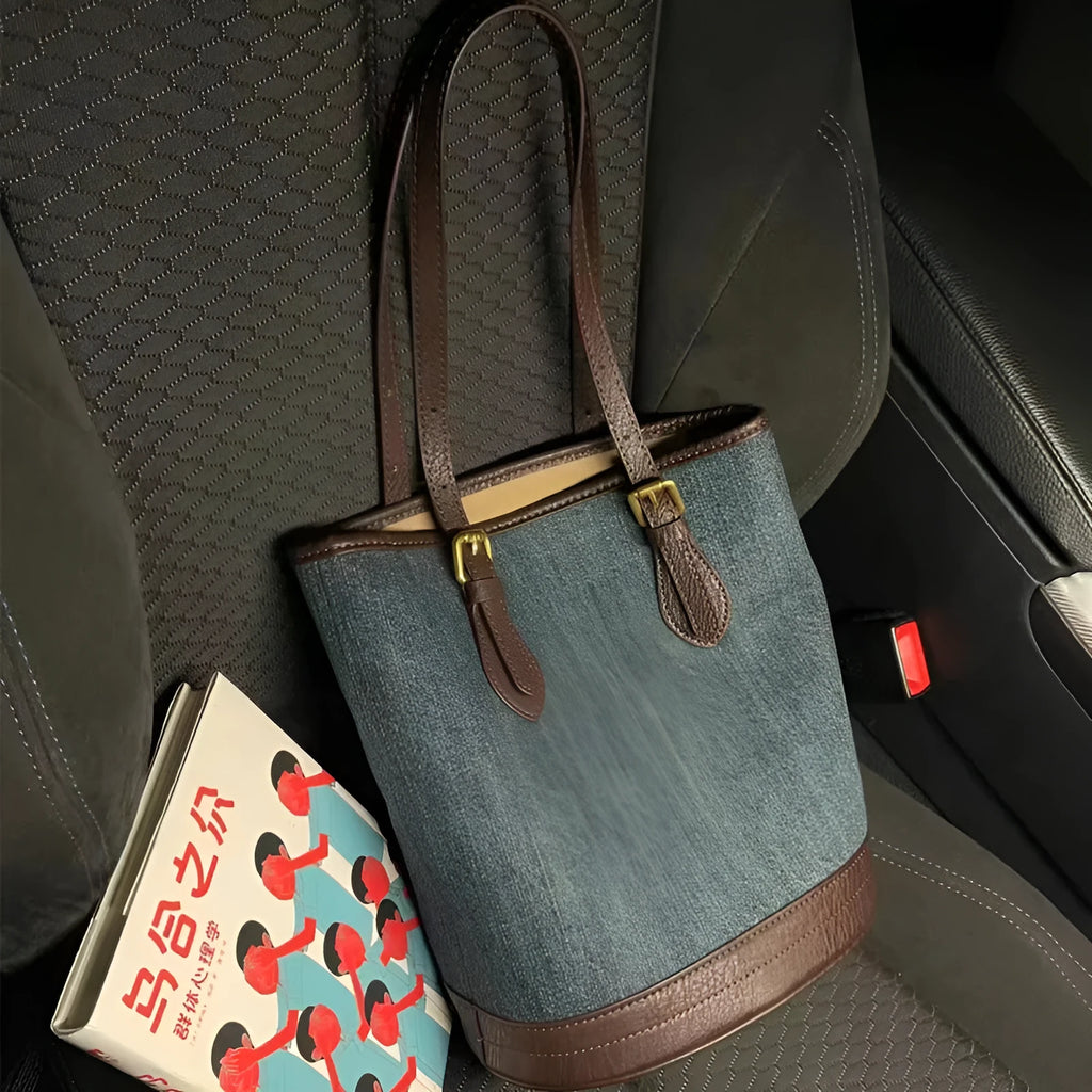 Denim patchwork handbag showing bucket shape with one-shoulder strap and patchwork detailing