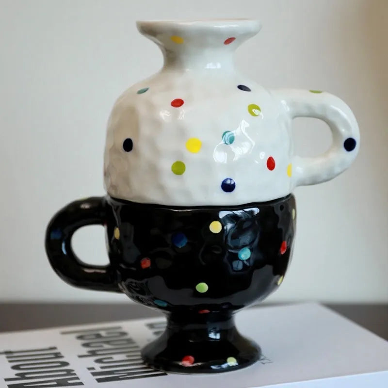 Hand-pinched irregular ceramic mug in a solid colour, showing its unique shape and modern design.
