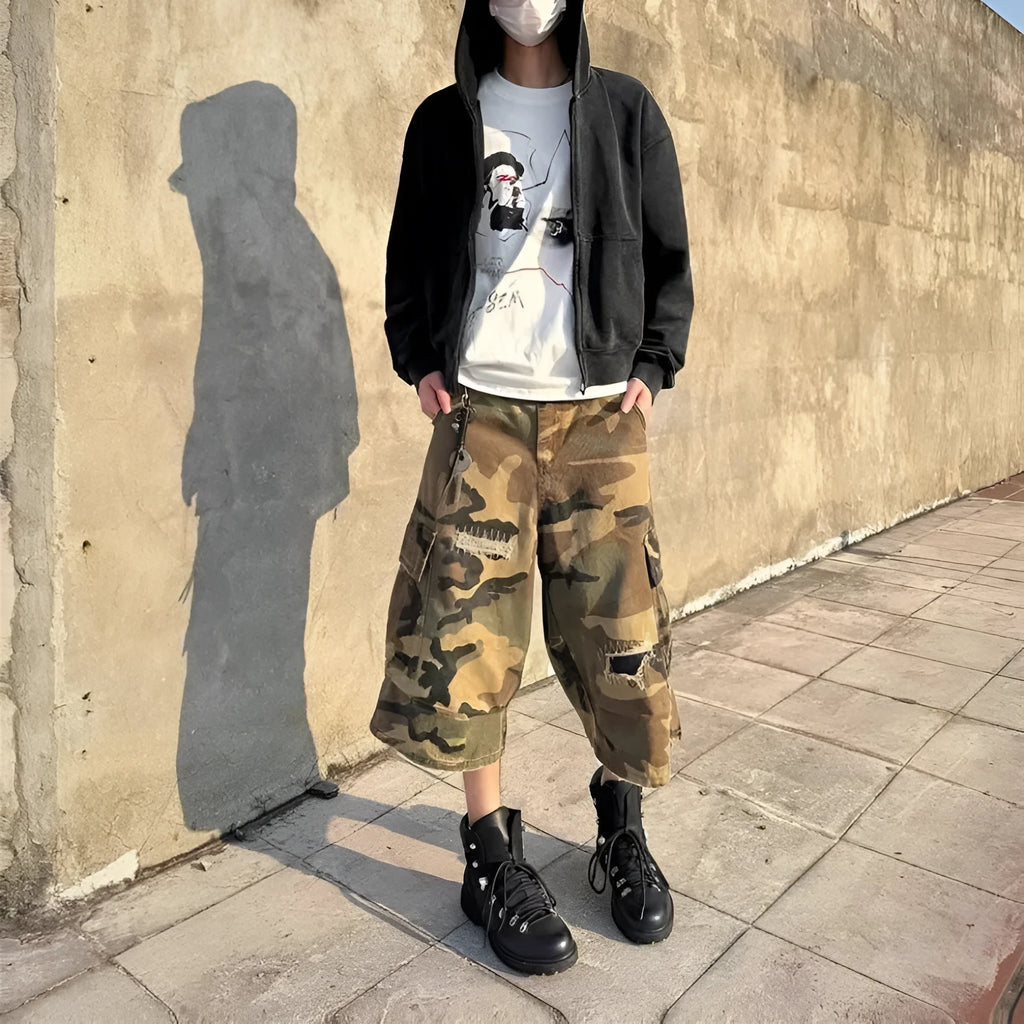 Men's loose fit camouflage patch ripped cropped jeans in a straight leg style.