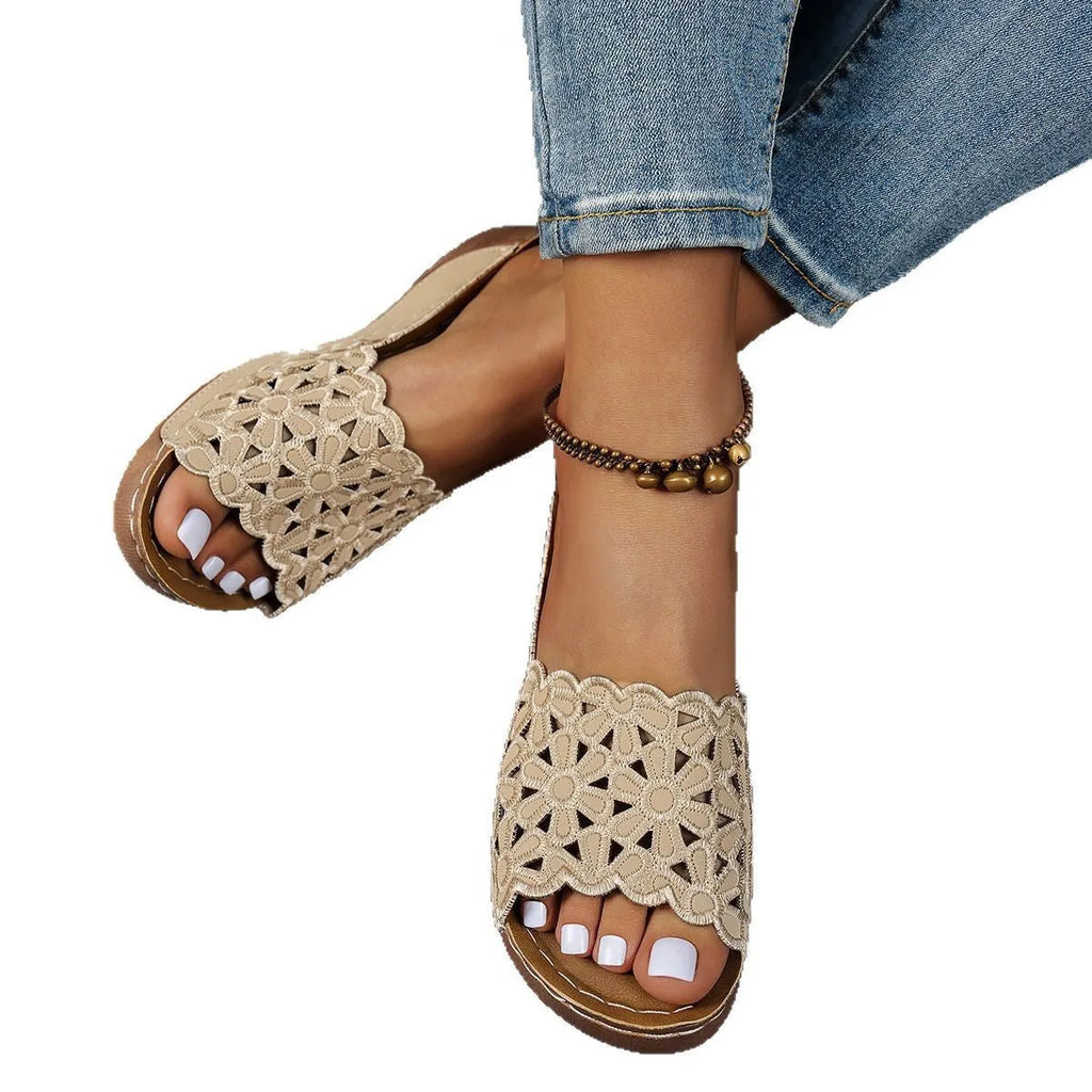 Women's wedge beach slippers with flower cutout design on PVC upper and fish-mouth toe shape.