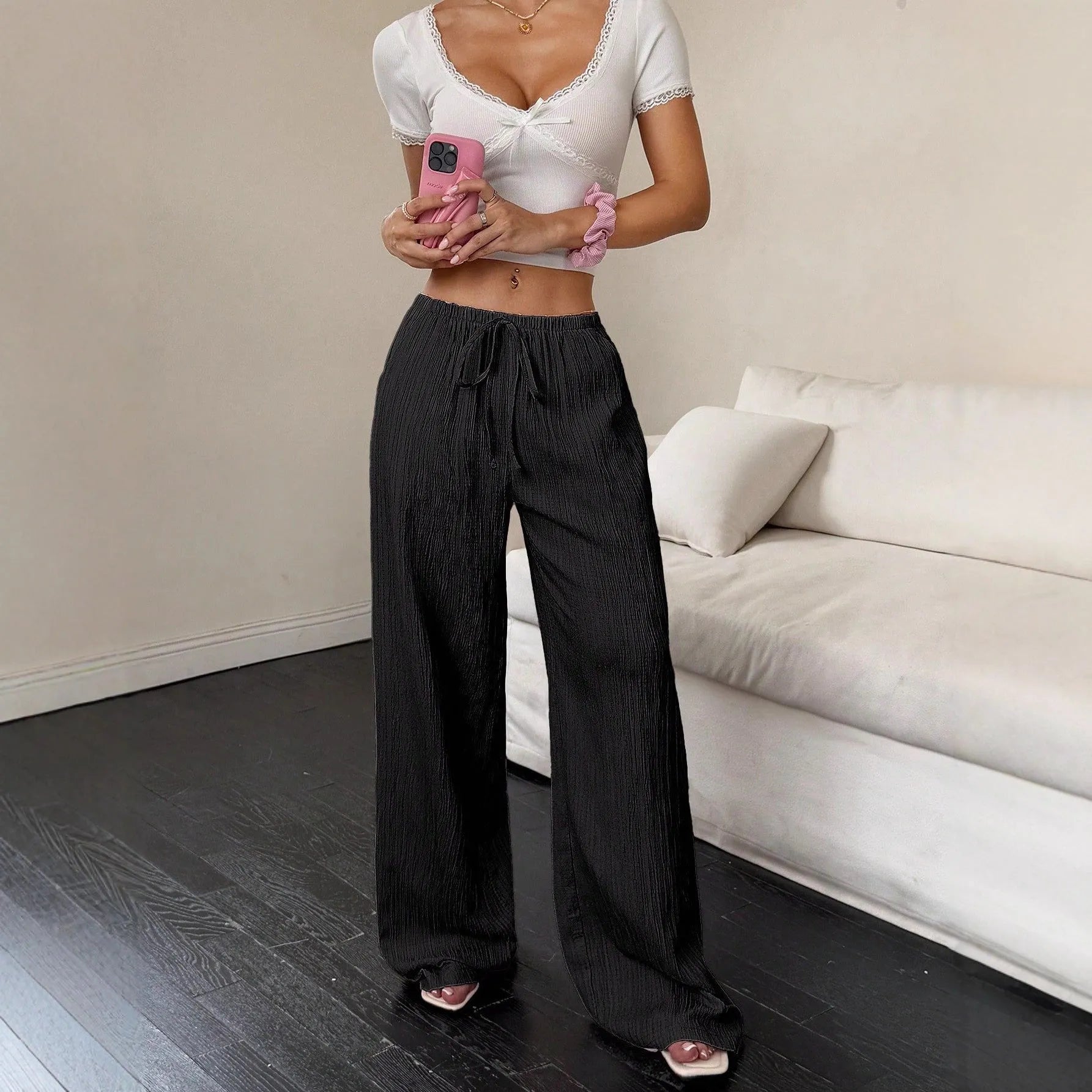 Women's black wide leg trousers with lace-up waist trimming detail on mid-waist