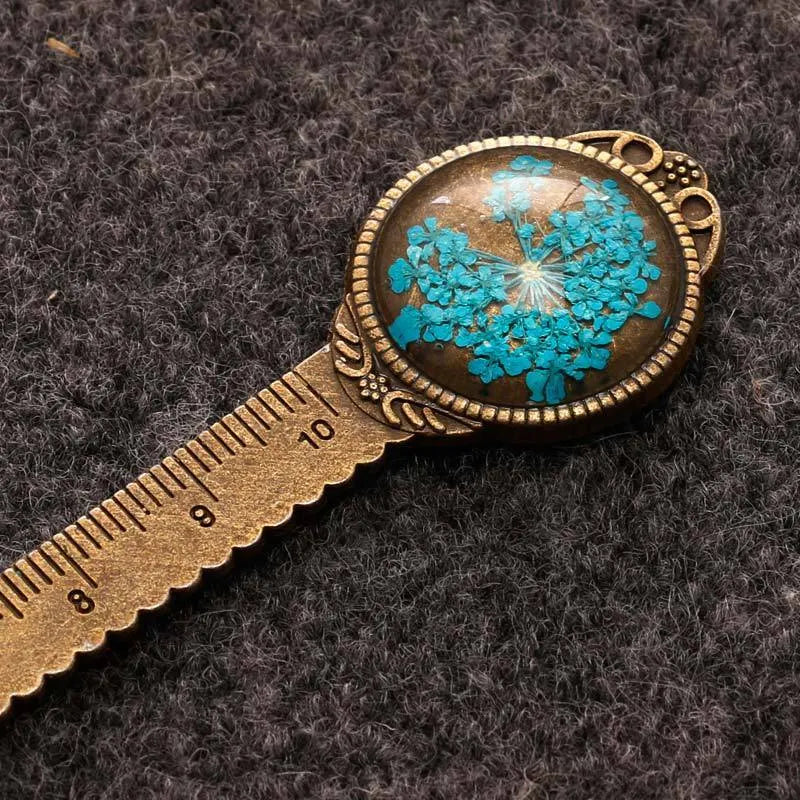 Handmade dried flower bookmark with ruler showing lace flowers, daffodils, and clover at 12cm length