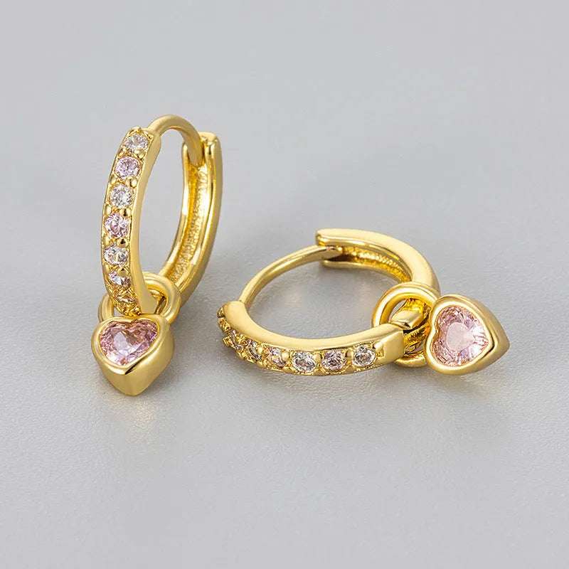 A pair of women's dangle earrings with a heart-shaped frame holding a coloured zircon stone.