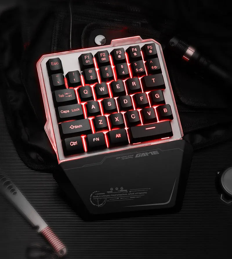 G40 black one-handed mechanical keyboard with RGB backlit keys on a desk.