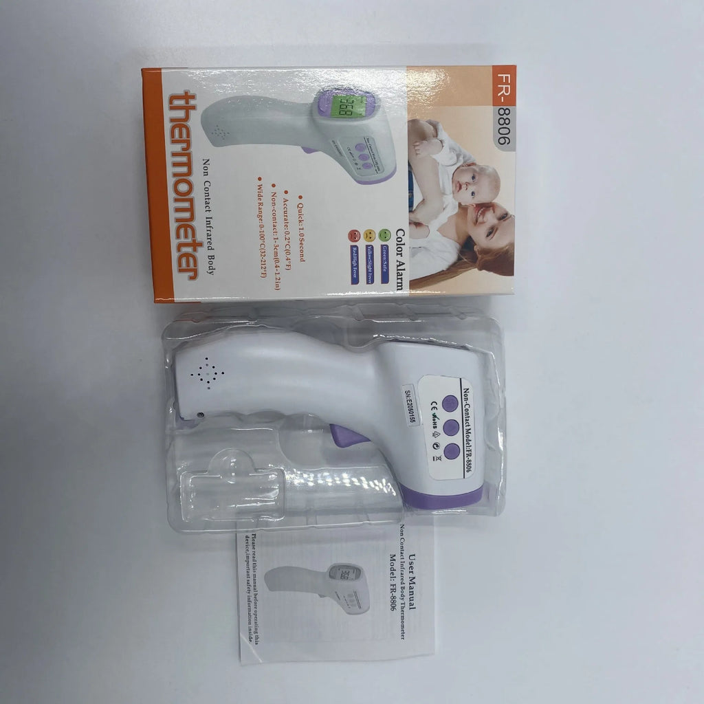 White digital thermometer for non-contact temperature measurement on a table.