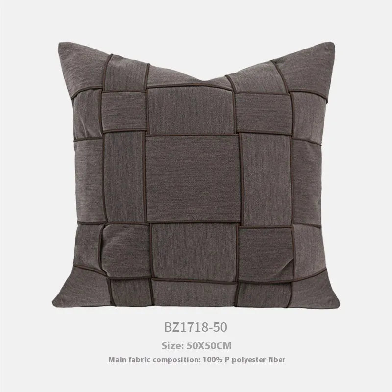 Square chenille woven sofa cushion in taupe colour on a grey sofa, showing textured fabric detail