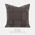 Square chenille woven sofa cushion in taupe colour on a grey sofa, showing textured fabric detail