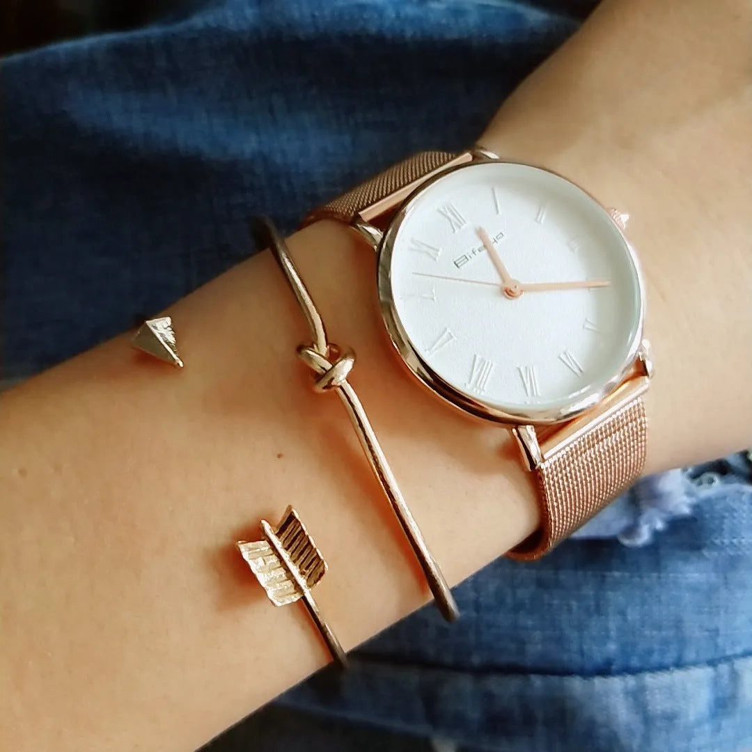 Gold electroplated alloy women's cuff bracelet with vintage arrow and knot design.