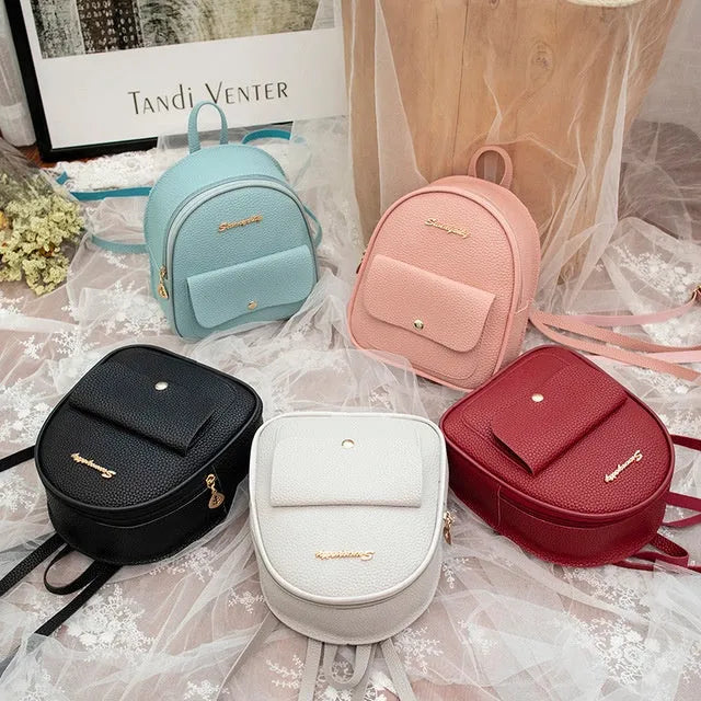 Small black PU shoulder backpack showing front zipper and dimensions